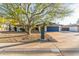 Well-maintained single-story home with blue garage door, tidy landscaping, and mature shade tree at 3531 E Becker Ln, Phoenix, AZ 85028