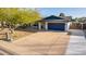 Home featuring a spacious driveway, mature trees and desert landscaping at 3531 E Becker Ln, Phoenix, AZ 85028