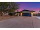 Charming home featuring a spacious driveway and a deep blue garage door at 3531 E Becker Ln, Phoenix, AZ 85028