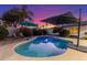 Inviting backyard pool area featuring lounge seating, shade umbrellas, and a captivating twilight sky at 3531 E Becker Ln, Phoenix, AZ 85028