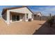 View of the backyard featuring a sliding glass door and low-maintenance gravel at 36529 W San Capistrano Ave, Maricopa, AZ 85138