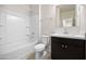 Bathroom features a shower-tub combo, a modern sink and a toilet at 36529 W San Capistrano Ave, Maricopa, AZ 85138