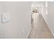 Long hallway view, leading to the living room and featuring neutral tile flooring at 36529 W San Capistrano Ave, Maricopa, AZ 85138