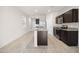 Modern kitchen featuring stainless steel appliances, granite countertops, and a breakfast bar at 36529 W San Capistrano Ave, Maricopa, AZ 85138