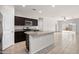 Bright, modern kitchen featuring stainless steel appliances, granite countertops, and an island at 36529 W San Capistrano Ave, Maricopa, AZ 85138