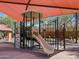 Outdoor play area featuring colorful play structures with protective shade canopies for children at 37013 W Prado St, Maricopa, AZ 85138