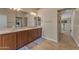 Neutral bathroom showcasing a double vanity with granite countertops and decorative blue rugs at 3707 N 188Th Ave, Litchfield Park, AZ 85340