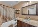 Neutral bathroom featuring a single vanity with granite countertop, a toilet, and a shower-tub combination at 3707 N 188Th Ave, Litchfield Park, AZ 85340