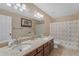 Well-lit bathroom offering a double vanity with granite counters and a shower-tub combination at 3707 N 188Th Ave, Litchfield Park, AZ 85340