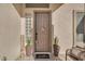 Inviting front entrance featuring a decorative door, a welcoming mat, and charming potted plants at 3707 N 188Th Ave, Litchfield Park, AZ 85340