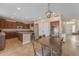 An open-concept kitchen features stainless steel appliances, a pantry, and a dining area with a modern light fixture at 3707 N 188Th Ave, Litchfield Park, AZ 85340