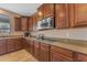 Updated kitchen featuring granite counters, stainless microwave, and dark wood cabinets at 3707 N 188Th Ave, Litchfield Park, AZ 85340