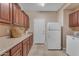 Functional laundry room with ample cabinet space, countertop, a refrigerator, and a washer at 3707 N 188Th Ave, Litchfield Park, AZ 85340