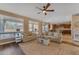 Bright and open living room with comfortable seating, large windows, and seamless kitchen access at 3707 N 188Th Ave, Litchfield Park, AZ 85340