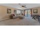 Comfortable living room with neutral furnishings, fan and access to a private deck at 3707 N 188Th Ave, Litchfield Park, AZ 85340