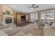 Cozy living room featuring a fireplace, a modern entertainment center and comfortable seating arrangements at 3707 N 188Th Ave, Litchfield Park, AZ 85340