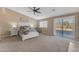 Serene main bedroom with a king-size bed, neutral decor, and a private balcony access at 3707 N 188Th Ave, Litchfield Park, AZ 85340