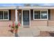 Inviting front entrance featuring a gray door with sidelights and decorative potted plants at 3724 E Joan De Arc Ave, Phoenix, AZ 85032