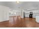 Bright kitchen with white cabinets, granite countertops, and stainless steel appliances, adjacent to the living area at 3724 E Joan De Arc Ave, Phoenix, AZ 85032