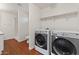 Functional laundry room featuring a shower, washer, dryer, and built-in storage shelves at 3724 E Joan De Arc Ave, Phoenix, AZ 85032