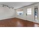 Bright living room featuring hardwood floors, white walls, and a well-lit entry with natural light at 3724 E Joan De Arc Ave, Phoenix, AZ 85032