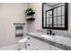 Modern bathroom with marble countertop vanity, open shelving, and sleek black framed shower at 4109 N 57Th St, Phoenix, AZ 85018