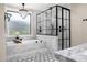 A luxurious bathroom featuring a soaking tub, a glass shower with black trim, and hexagon tile flooring at 4109 N 57Th St, Phoenix, AZ 85018