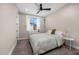 Bedroom with large window, ceiling fan and neutral colored walls with a queen size bed and carpet at 4109 N 57Th St, Phoenix, AZ 85018