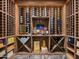 Detailed view of wine cellar with wood shelving and curated wine selection at 4109 N 57Th St, Phoenix, AZ 85018