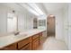 Bright bathroom featuring an arched doorway, double vanity, and ample storage at 4200 N Miller Rd # 220, Scottsdale, AZ 85251