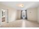 Bright bedroom featuring light wood floors, a window with curtains, and access to an ensuite bathroom at 4200 N Miller Rd # 220, Scottsdale, AZ 85251