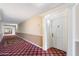 Hallway featuring neutral walls with decorative trim and patterned carpet to unit 220 at 4200 N Miller Rd # 220, Scottsdale, AZ 85251