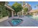 Relaxing hot tub with nearby lounge chairs and landscaping, complementing the community pool area at 4200 N Miller Rd # 220, Scottsdale, AZ 85251