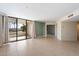 Bright living room with neutral walls, tile flooring, and slider door access to the outside patio at 4200 N Miller Rd # 220, Scottsdale, AZ 85251