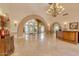 Elegant lobby showcasing travertine floors, arched entryways, and a chandelier at 4200 N Miller Rd # 220, Scottsdale, AZ 85251