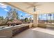 Covered outdoor patio featuring tiled flooring, decorative lattice accents, and a ceiling fan for comfort at 4200 N Miller Rd # 220, Scottsdale, AZ 85251