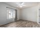 Bright bedroom with a window overlooking the neighborhood, a ceiling fan, and plank flooring at 4455 E Paradise Village S Pkwy # 1068, Phoenix, AZ 85032