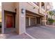 Close up of a condo's exterior features, including garage, door, and brick driveway at 4455 E Paradise Village S Pkwy # 1068, Phoenix, AZ 85032