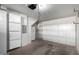 A garage featuring an electric garage door opener, storage units, and a refrigerator at 4455 E Paradise Village S Pkwy # 1068, Phoenix, AZ 85032