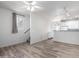 Bright living room with wood-look floors, white walls, and a view of the stairs and the kitchen at 4455 E Paradise Village S Pkwy # 1068, Phoenix, AZ 85032