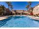 Large community pool surrounded by palm trees and lounge chairs perfect for relaxing and enjoying the outdoors at 4455 E Paradise Village S Pkwy # 1068, Phoenix, AZ 85032