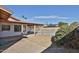 This backyard features a covered patio, block fence, swimming pool, and desert landscaping at 4536 W Bloomfield Rd, Glendale, AZ 85304