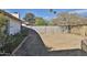 This backyard features a block fence and desert landscaping, with trees and desert plants at 4536 W Bloomfield Rd, Glendale, AZ 85304