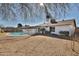 View of the home's backyard, showcasing the pool and well-maintained lawn at 4536 W Bloomfield Rd, Glendale, AZ 85304