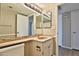 Neutral bathroom features a granite countertop, framed mirror, and updated fixtures at 4536 W Bloomfield Rd, Glendale, AZ 85304