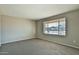 Bedroom with neutral colored walls, carpet and a window offering natural light at 4536 W Bloomfield Rd, Glendale, AZ 85304