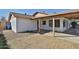 The exterior of this home features a covered patio, desert landscaping and updated windows at 4536 W Bloomfield Rd, Glendale, AZ 85304