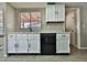 Kitchen area featuring white cabinets and modern black dishwasher at 4536 W Bloomfield Rd, Glendale, AZ 85304