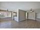 Open-concept living area with wood laminate floors and two ceiling fans at 4536 W Bloomfield Rd, Glendale, AZ 85304