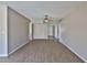 Spacious living area with neutral walls, wood laminate flooring and a ceiling fan at 4536 W Bloomfield Rd, Glendale, AZ 85304